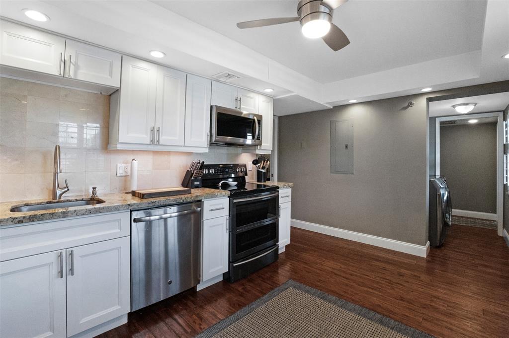 3095 North Course Drive, Unit 203 Pompano Beach, FL 33069 - Photo 16 of 49 a kitchen with a sink stainless steel appliances and cabinets