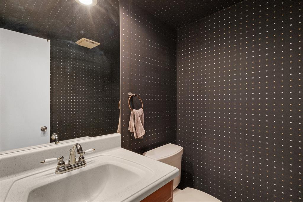 3095 North Course Drive, Unit 203 Pompano Beach, FL 33069 - Photo 19 of 49 a bathroom with a sink a toilet and a mirror