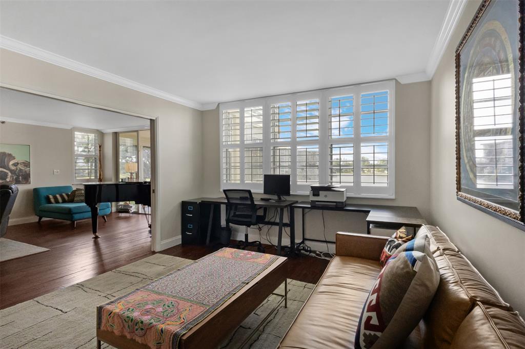 3095 North Course Drive, Unit 203 Pompano Beach, FL 33069 - Photo 22 of 49 a living room with furniture and wooden floor