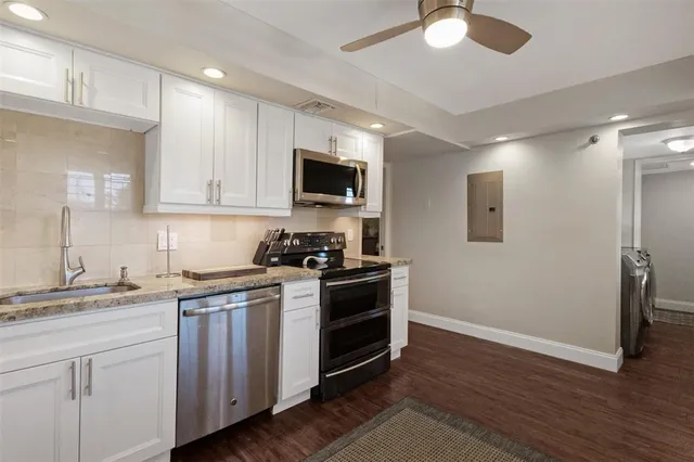 a view of a hallway and dining room with a mirror