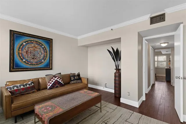 a bedroom with a bed and a mirror on dresser