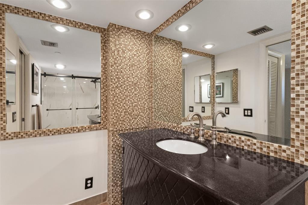 3095 North Course Drive, Unit 203 Pompano Beach, FL 33069 - Photo 32 of 49 a bathroom with a sink double vanity and a mirror