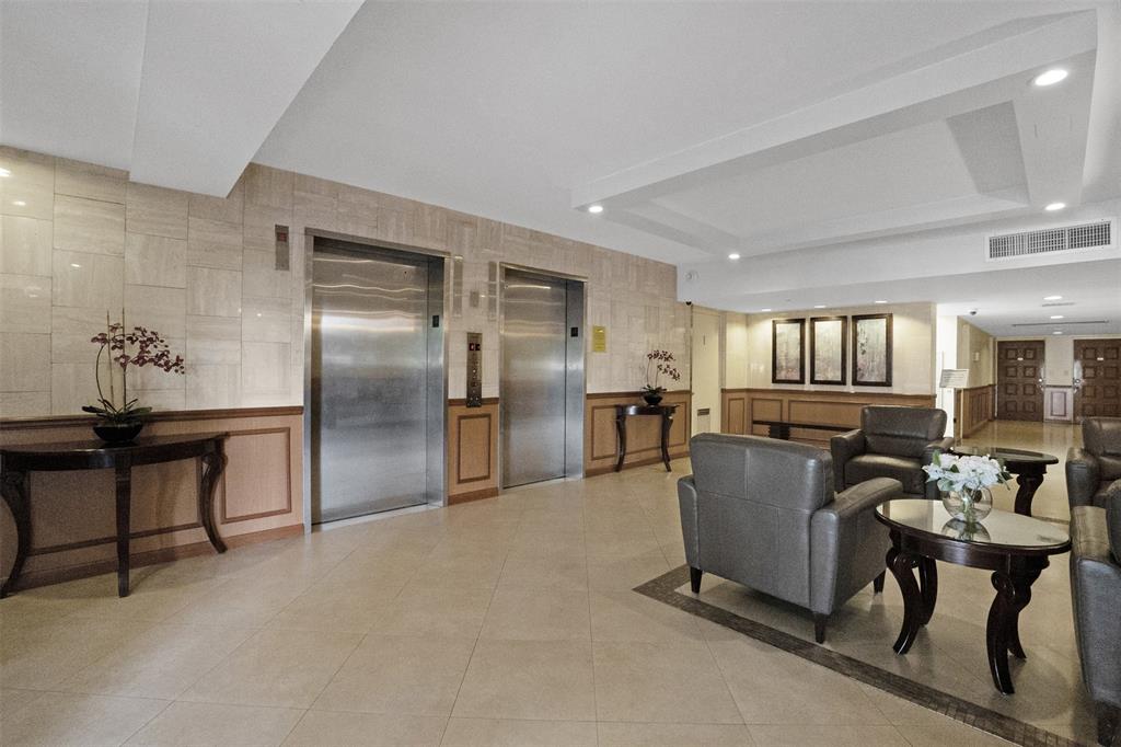 3095 North Course Drive, Unit 203 Pompano Beach, FL 33069 - Photo 41 of 49 a living room with furniture a dining table and kitchen view