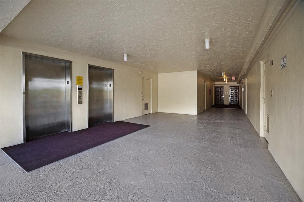 3095 North Course Drive, Unit 203 Pompano Beach, FL 33069 - Photo 42 of 49 a view of a big room with closet and a projector
