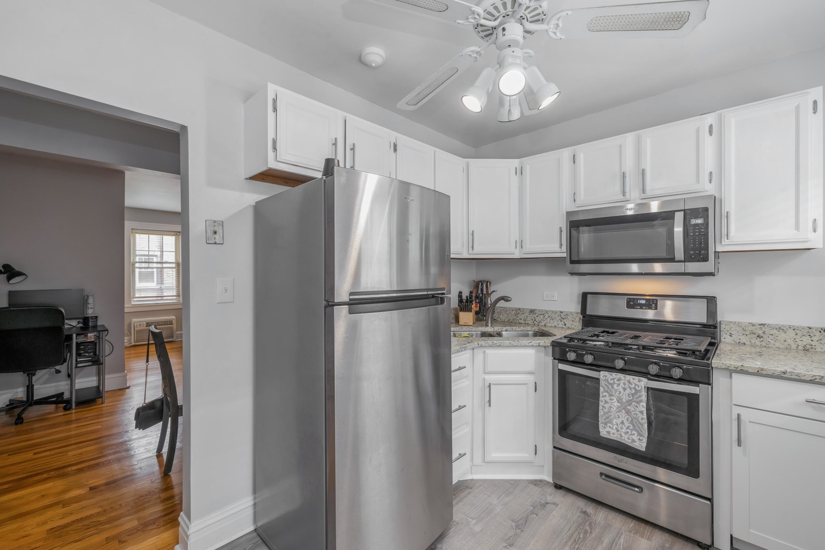 110 Lincoln Avenue, Unit 2B Riverside, IL 60546 - Photo 6 of 11 a kitchen with cabinets stainless steel appliances and wooden floor