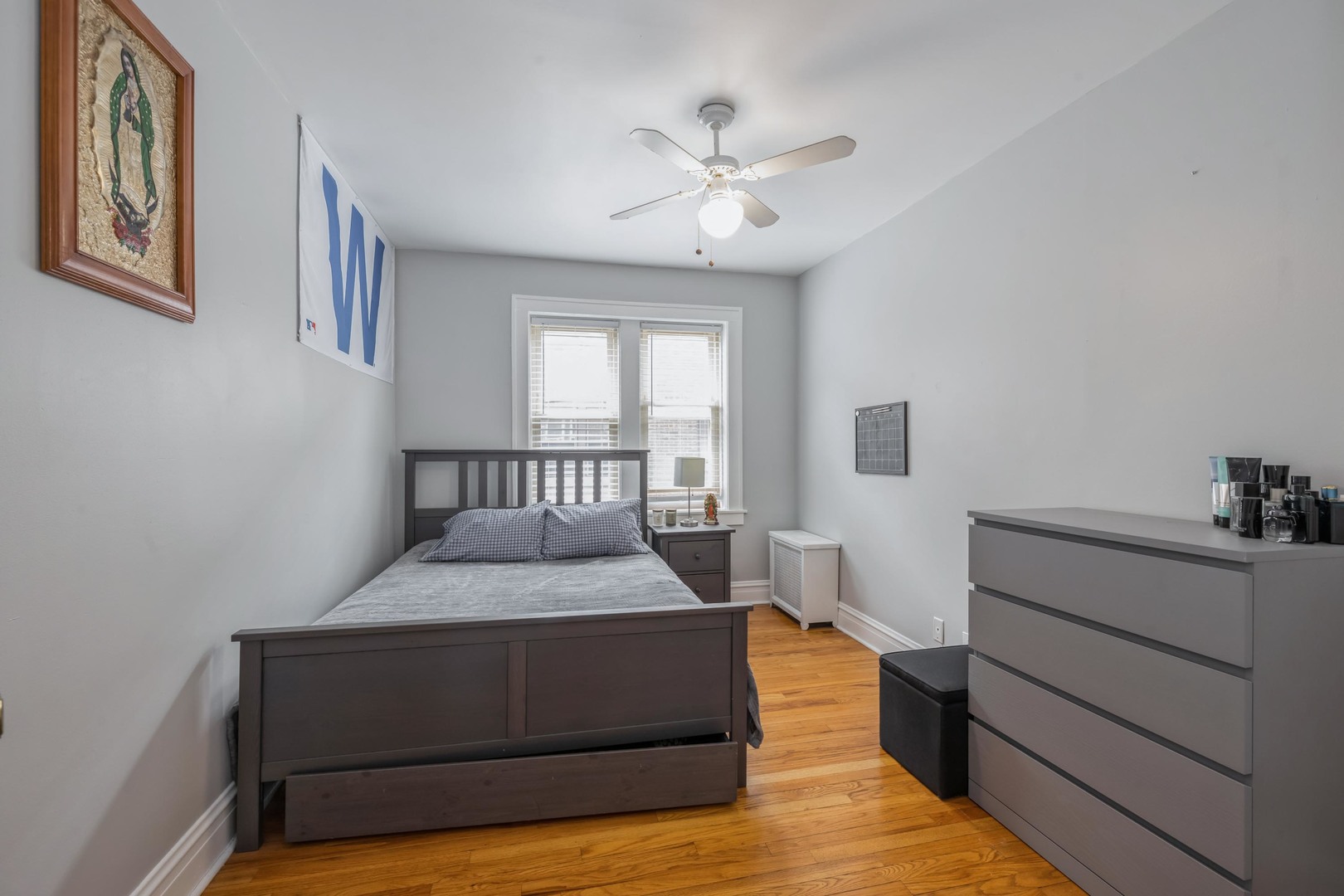 110 Lincoln Avenue, Unit 2B Riverside, IL 60546 - Photo 8 of 11 a bedroom with a large bed and a chandelier