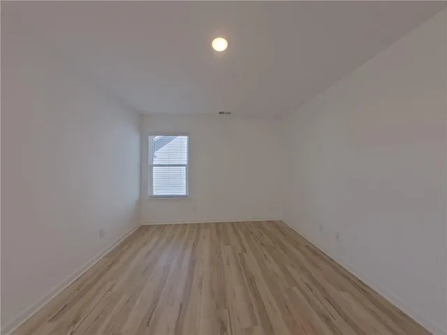 a view of room with window and hardwood floor