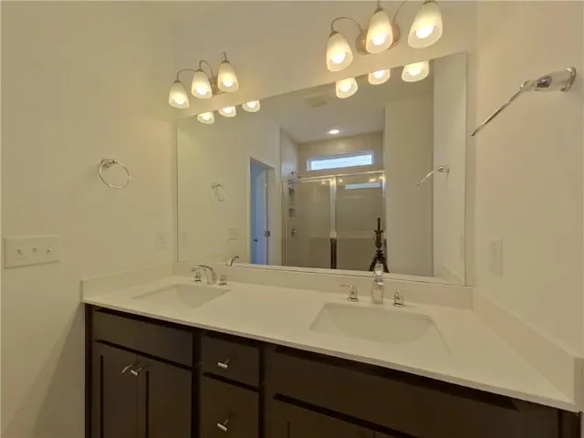 a bathroom with a double vanity sink and a mirror