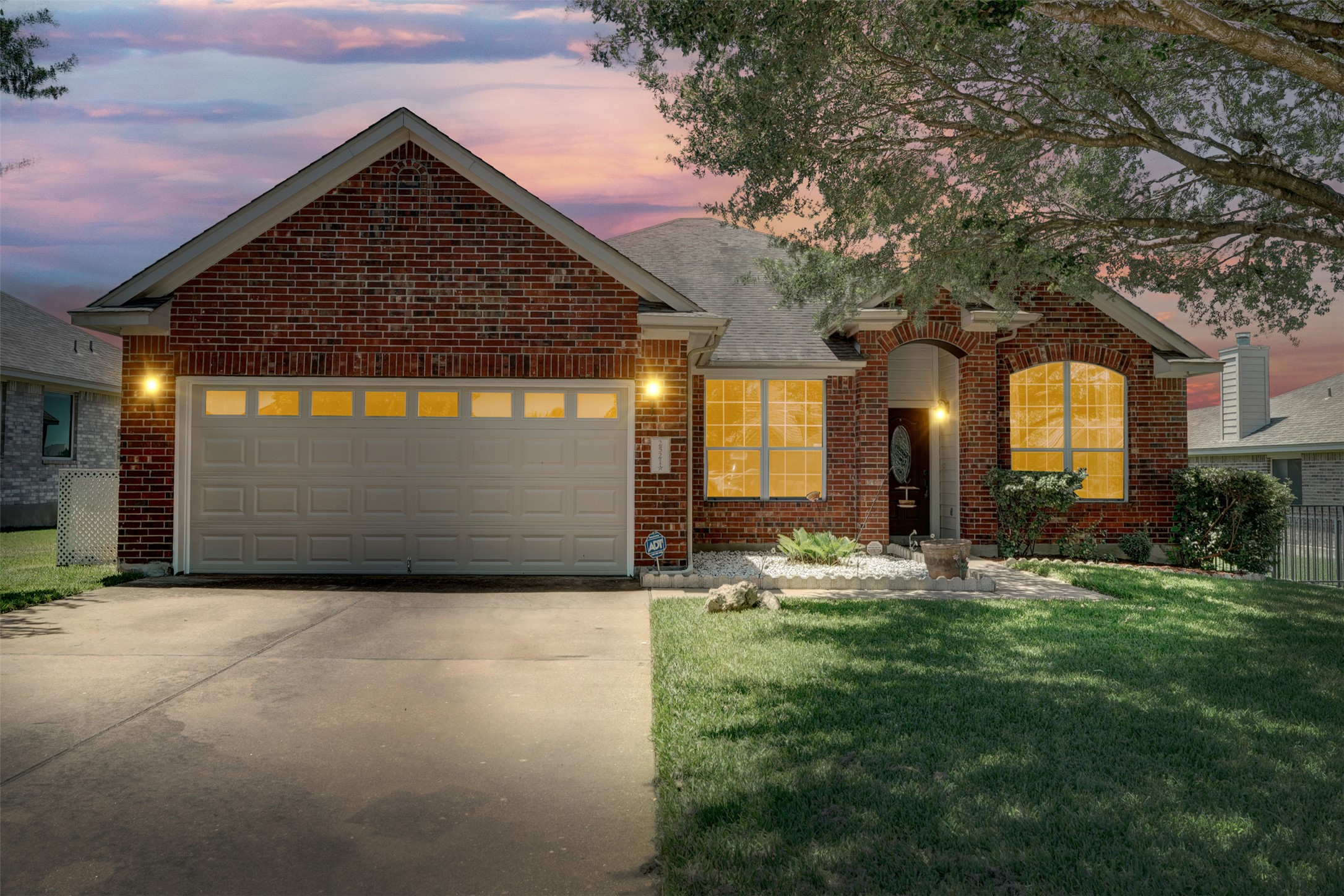 2521 Amen Corner Road Pflugerville, TX 78660 - Photo 1 of 40 Brick exterior residence featuring an attached two-car garage with transom window accents