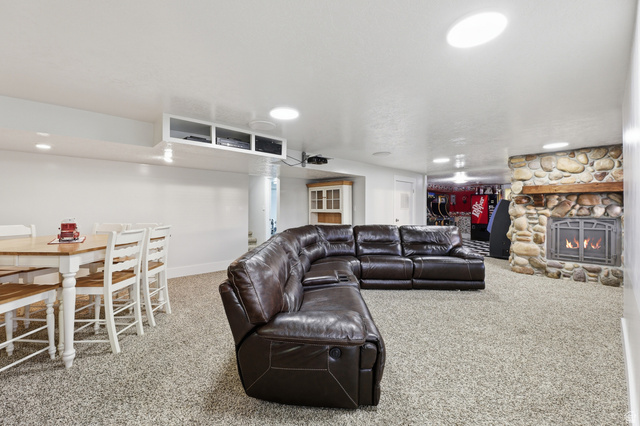 2342 Charros Road Sandy, UT 84092 - Photo 47 of 94 Entertainment room featuring a stone fireplace with a wood mantle, recessed lighting, and carpet flooring