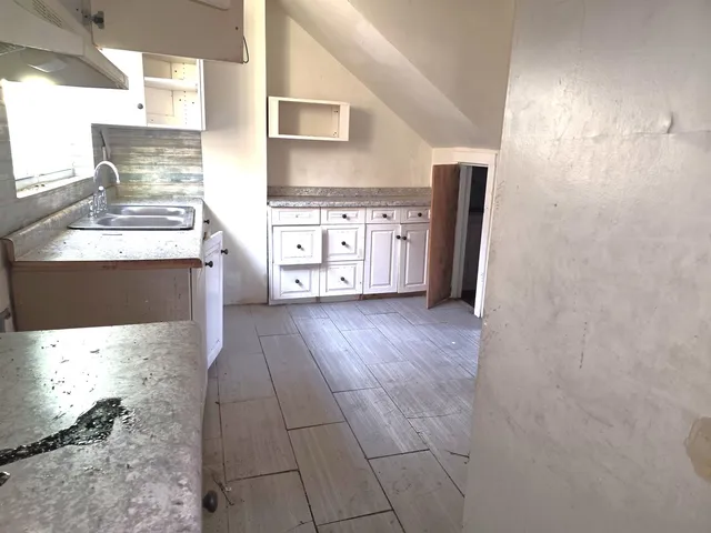 a kitchen with stainless steel appliances a refrigerator and a stove