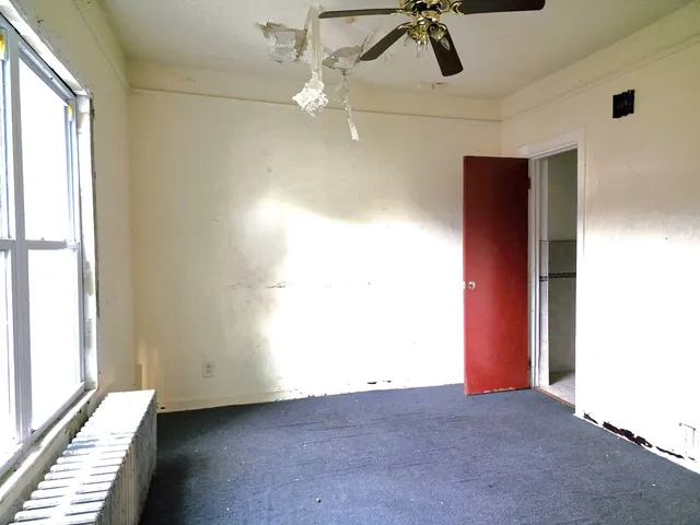 a view of a room with a ceiling fan