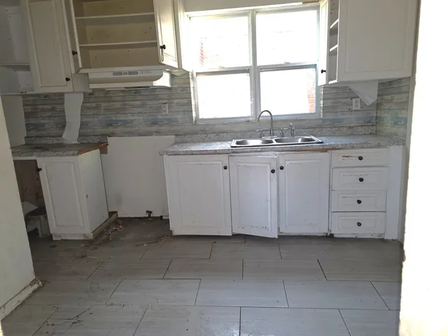 a view of a kitchen with granite countertop cabinets