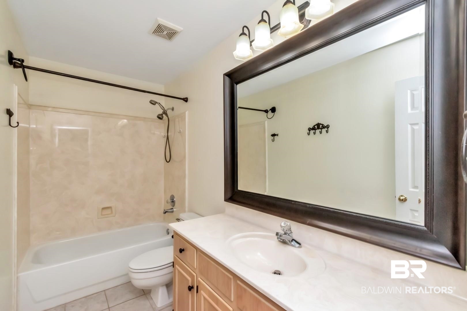 1071 Southern Way Court Mobile, AL 36609 - Photo 25 of 44 Full bathroom featuring vanity, toilet, tile patterned flooring, and bathtub / shower combination