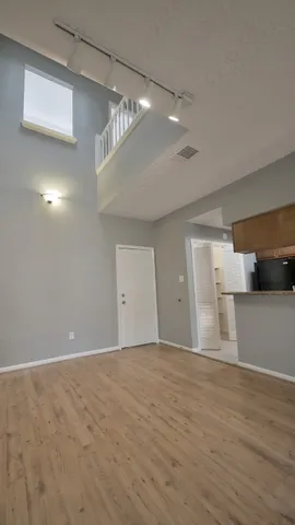 a kitchen with granite countertop a refrigerator and a stove top oven
