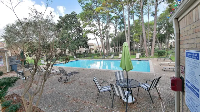 a view of a backyard with sitting area