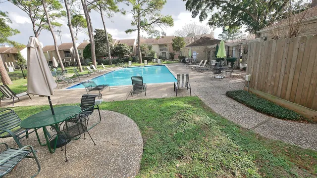 an outdoor space with seating area and trees