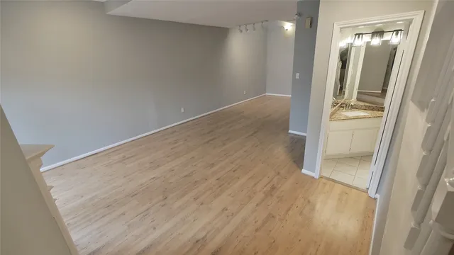 a view of a livingroom with a fireplace wooden floor and windows