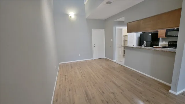 a kitchen with stainless steel appliances a white stove top oven and a refrigerator