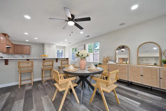 a view of a dining room with furniture and wooden floor