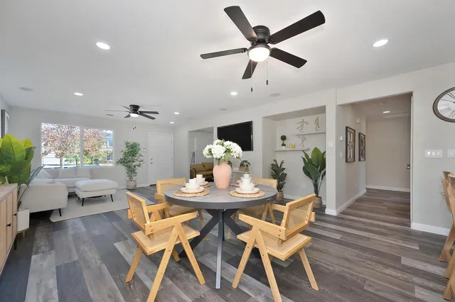 a view of a dining room with furniture and wooden floor