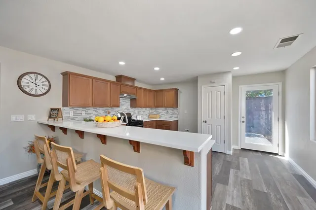 a large kitchen with a table and chairs