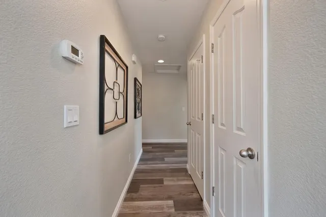a view of a hallway with paintings on the wall
