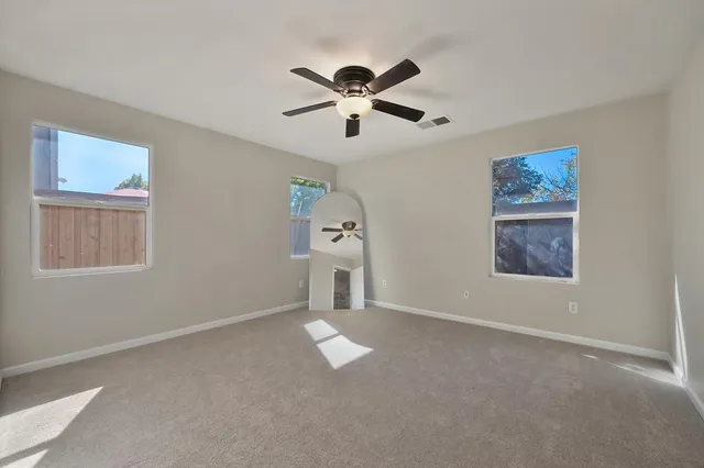 a view of a livingroom with a ceiling fan window and a ceiling fan