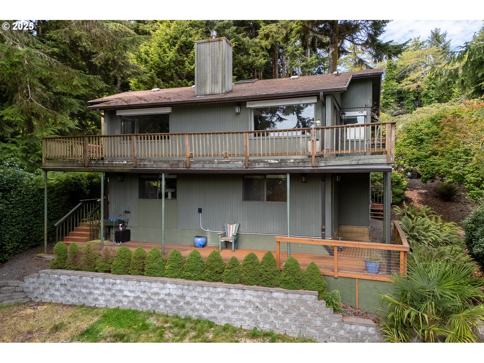 2011 Devil's Ridge Road Lincoln City, OR 97367 - Photo 2 of 24 a front view of a house with a garden