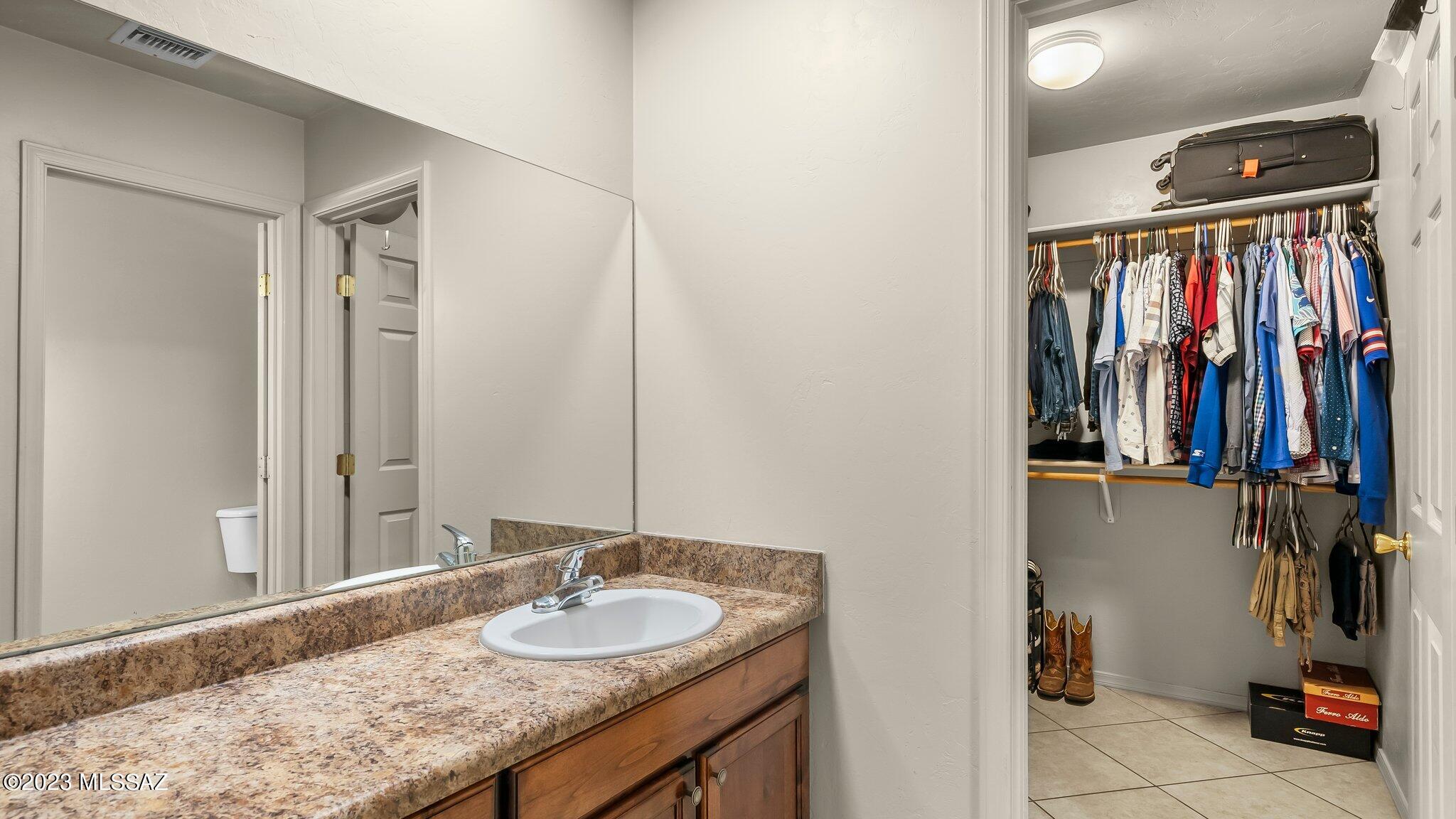 96 Calle Quintana Rio Rico, AZ 85648 - Photo 25 of 30 a bathroom with a granite countertop double vanity