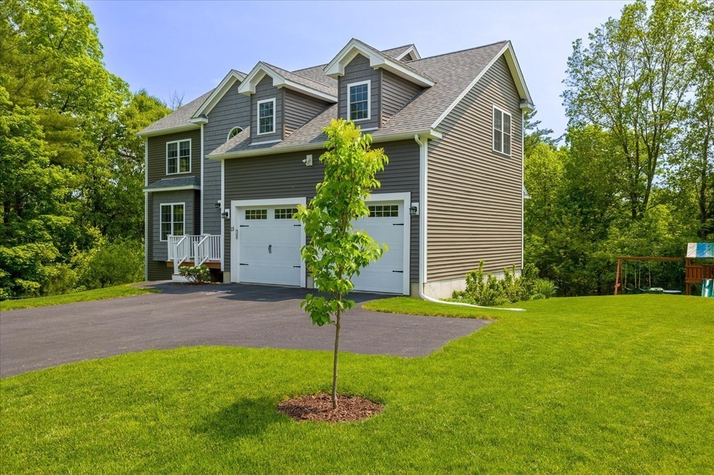 15 Tannery Road Sturbridge, MA 01518 - Photo 2 of 41 a front view of a house with a yard and garage