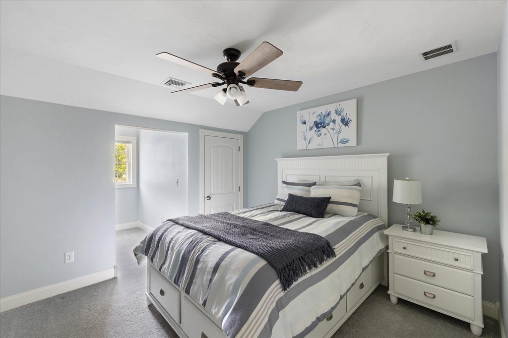15 Tannery Road Sturbridge, MA 01518 - Photo 25 of 41 a bedroom with a bed and a chandelier