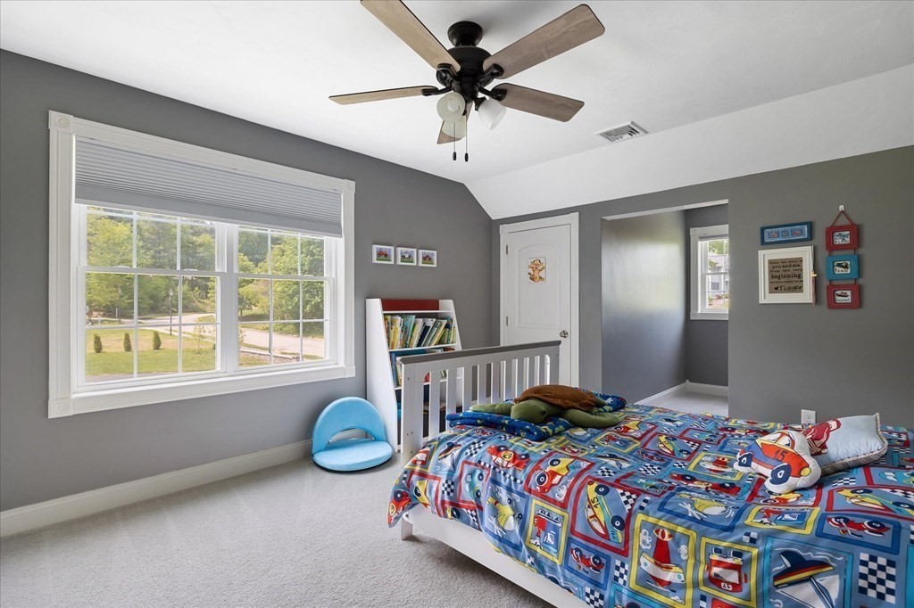 15 Tannery Road Sturbridge, MA 01518 - Photo 27 of 41 a bedroom with a bed and a chandelier