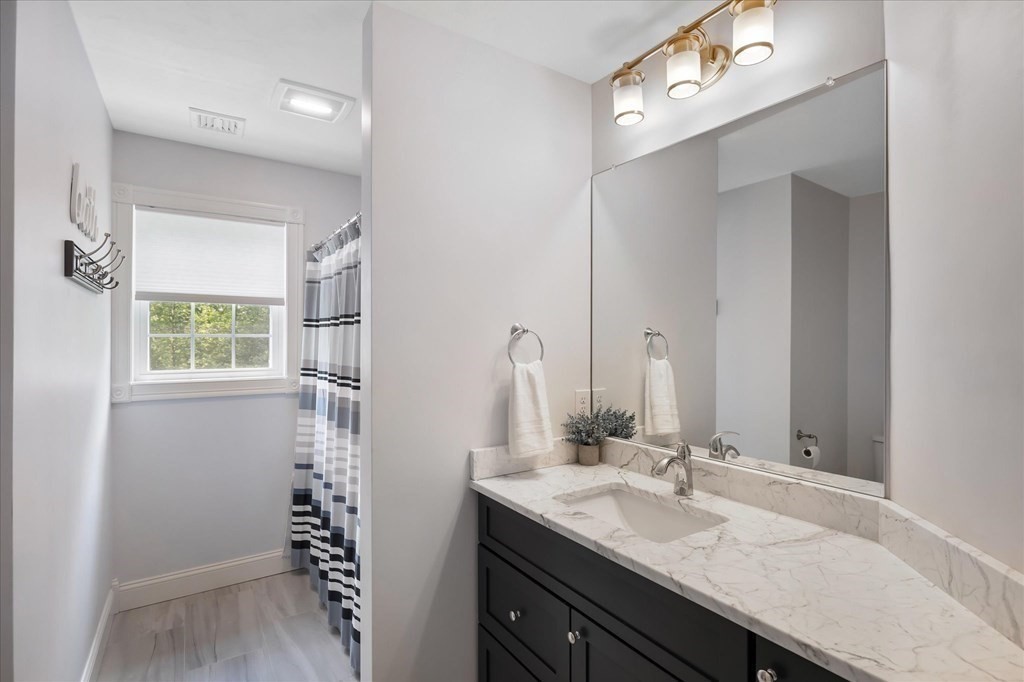 15 Tannery Road Sturbridge, MA 01518 - Photo 29 of 41 a bathroom with a granite countertop sink and a mirror