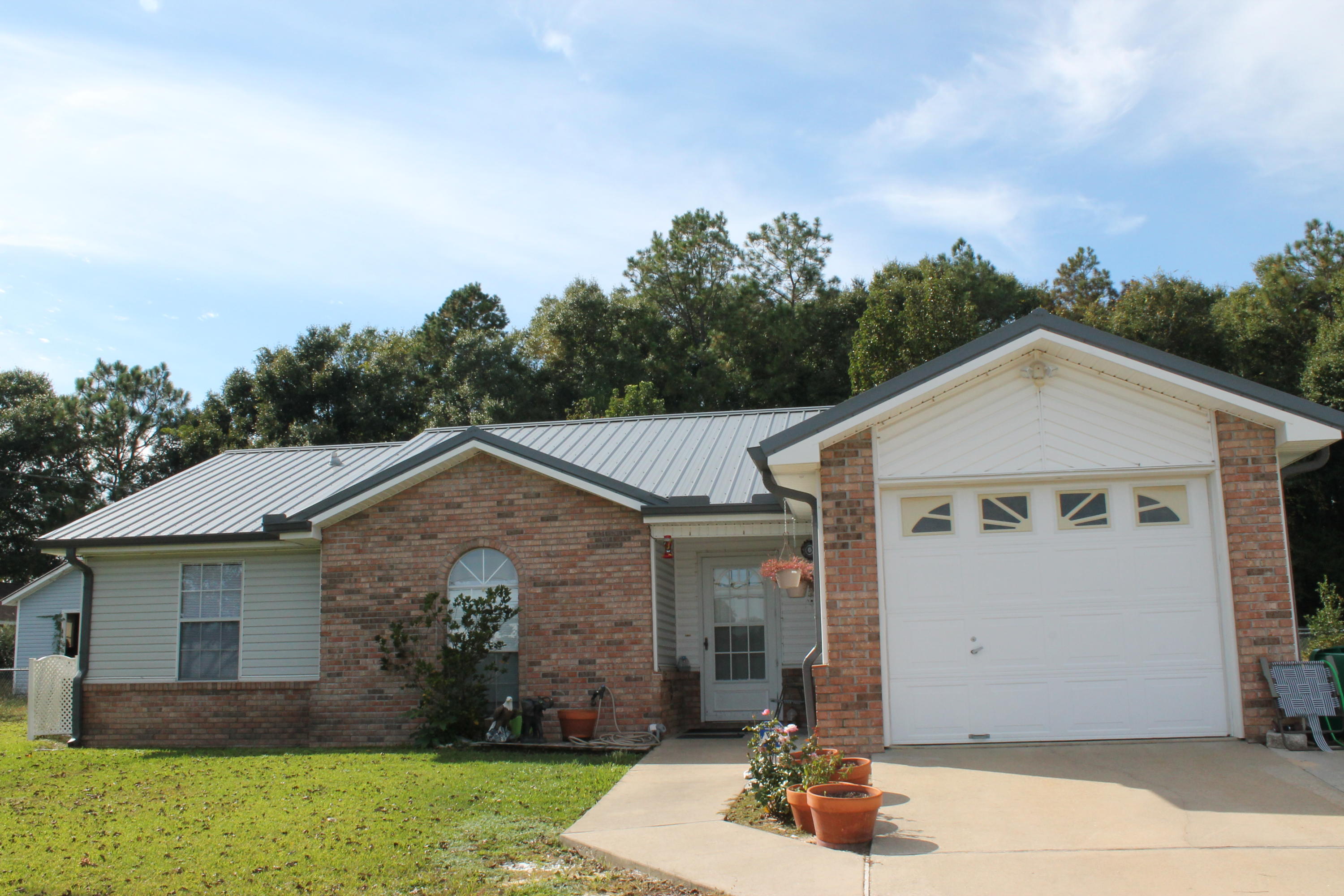 1019 Valley Road Crestview, FL 32539 - Photo 1 of 1 a view of a house with backyard and garden
