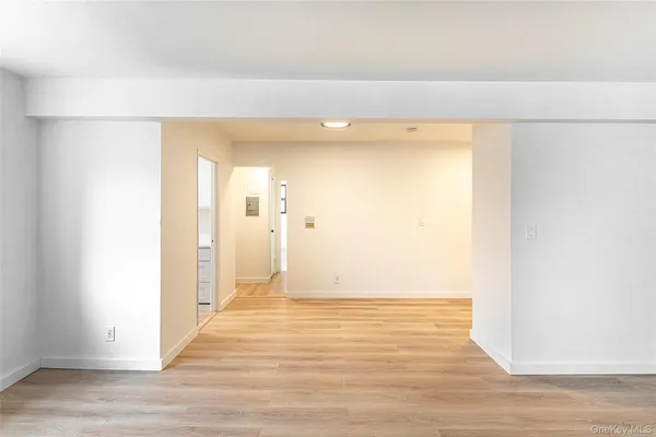 a view of a room with wooden floor