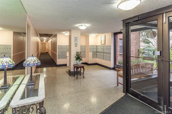 a lobby with furniture and floor to ceiling window