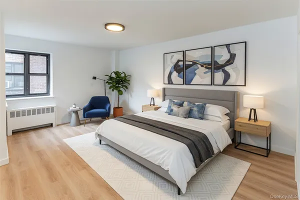 a bedroom with a bed a mirror and a potted plant on dresser