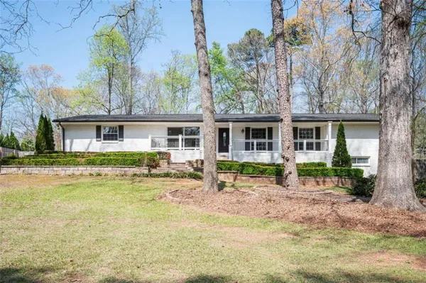 a front view of house with yard and green space