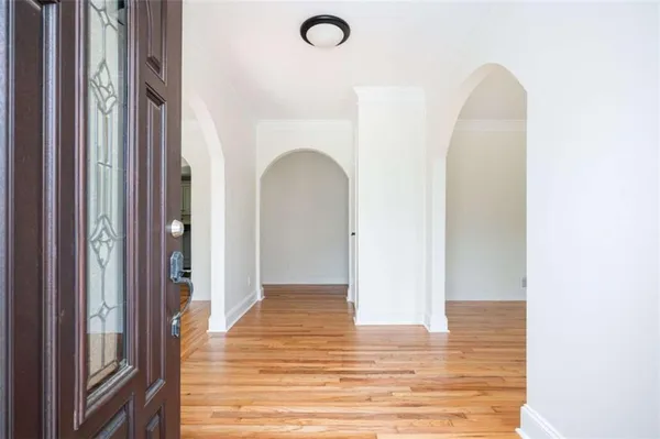 a view of a room with wooden floor and white doors