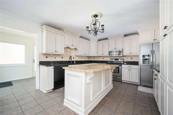a kitchen with a sink stove and refrigerator