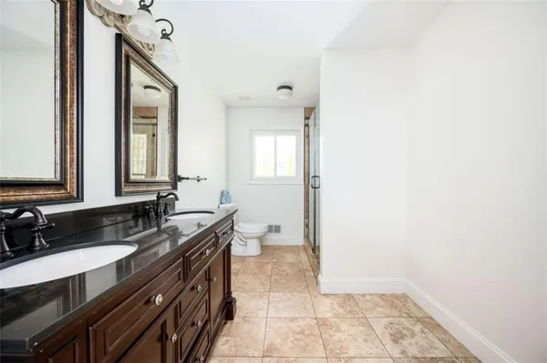 a bathroom with a sink a toilet and a mirror
