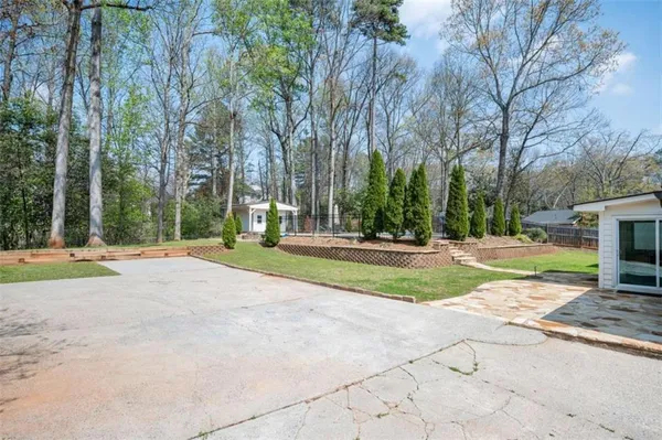 a view of a house with swimming pool and sitting area