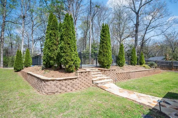 a view of a house with pool and sitting area