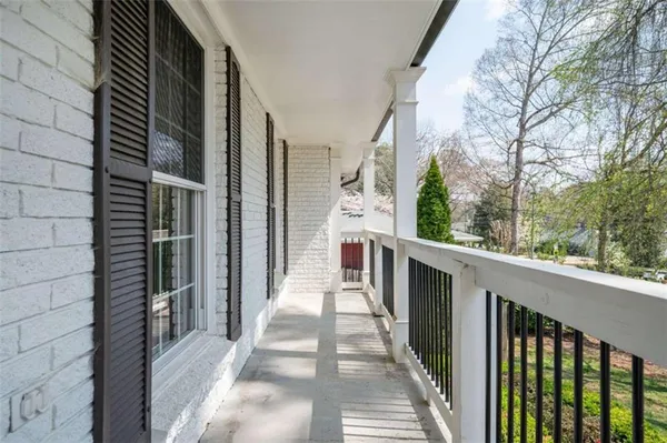 a view of balcony with wooden floor and fence