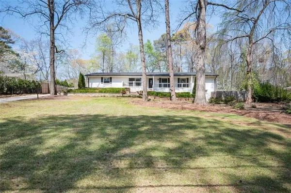 a view of a house with a yard and plants