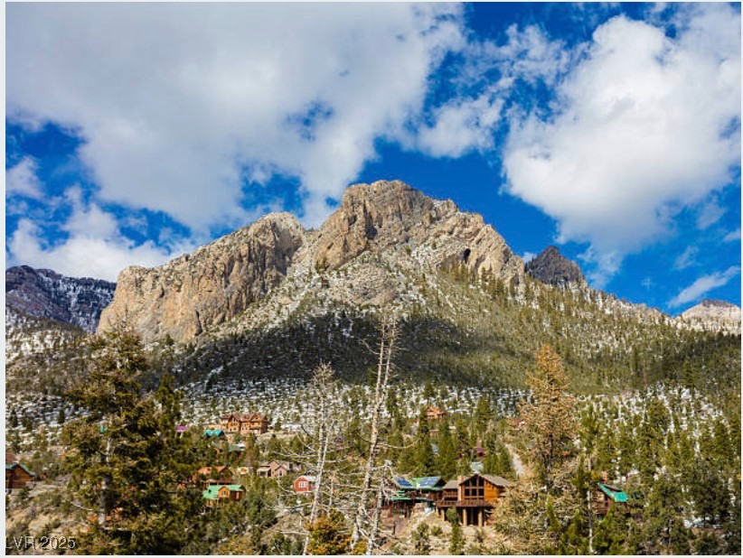 4096 Tyrol Way Mount Charleston, NV 89124 - Photo 47 of 50 Majestic peaks pierce through wispy clouds creating stunning alpine vistas. These dramatic mountain views reward hikers on trails like Trail Canyon and North Loop leading to Mt. Charleston's summit.