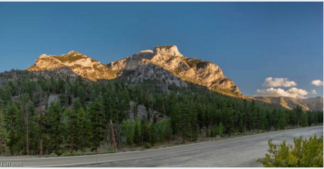 4096 Tyrol Way Mount Charleston, NV 89124 - Photo 50 of 50 Sunrise bathes the mountain peaks in warm golden light, beginning a new day of outdoor adventure. This spectacular vista captures the timeless beauty that makes Mt. Charleston a world-class destination for hiking, skiing, and nature enthusiasts.