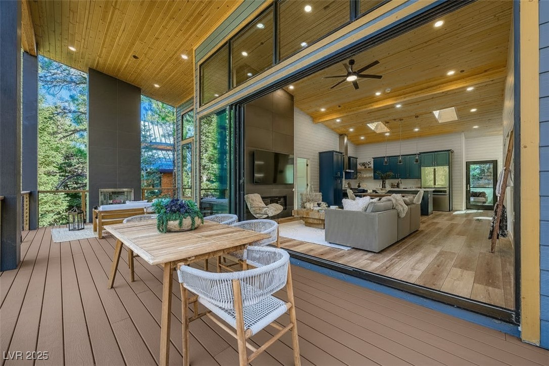 4096 Tyrol Way Mount Charleston, NV 89124 - Photo 7 of 50 The upstairs deck is the best place for serenity and connection to the world and forest around us. With 2 woodburning fireplaces outside, one up and one down, these 2 outdoor decks allow for endless moments and space making. The upper deck has massive panoramic views with ground to ceiling span of almost 40'. The top deck is the pinnacle of indoor/outdoor living space. creating a massive perfect place to connect with the surroundings. Stand on the deck. Soak in the nature.