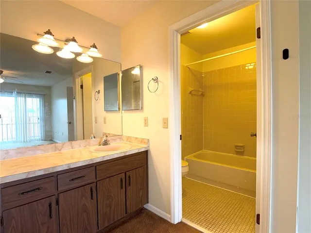 a bathroom with a shower a sink and a mirror